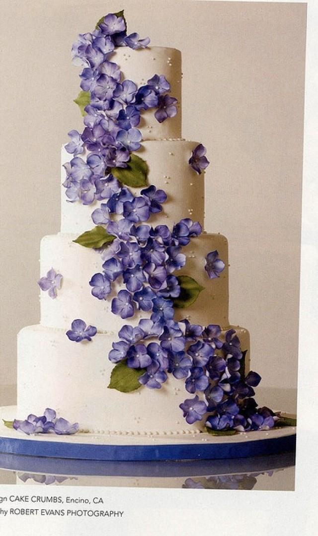 wedding photo - Wedding cake with purple colored blossoms.