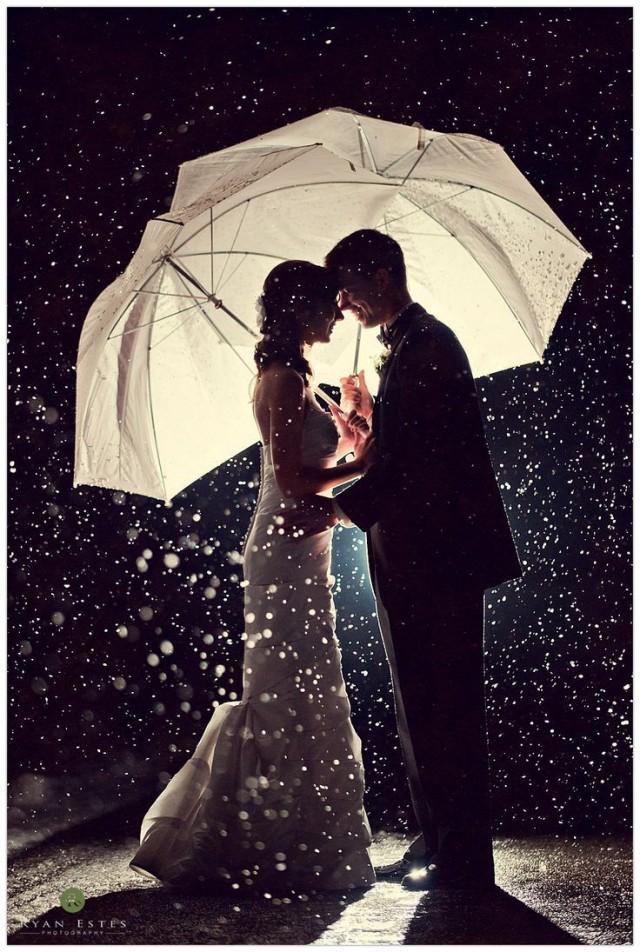 wedding photo - Wedding photography where the couple is holding umbrellas.