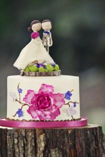 wedding photo - Ivory wedding cake with bride and groom at the top
